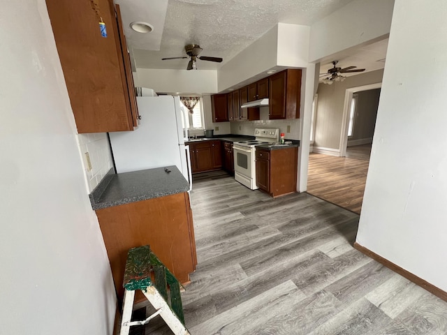 kitchen featuring ceiling fan, a textured ceiling, white appliances, and light hardwood / wood-style floors