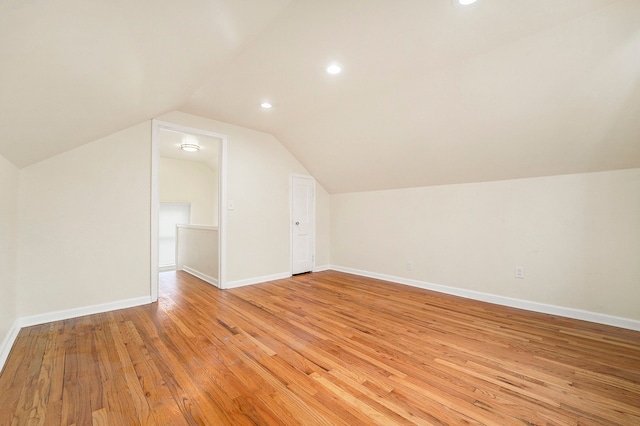 bonus room featuring vaulted ceiling and light hardwood / wood-style flooring