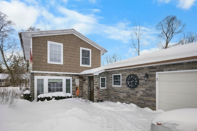 view of front of home with a garage and stone siding