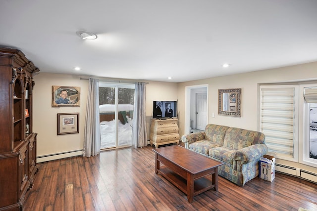 living area featuring dark wood-type flooring, a baseboard radiator, and recessed lighting