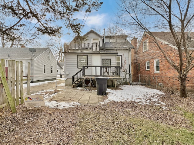 back of property with a balcony