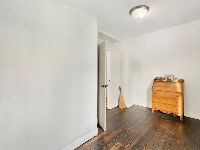 interior space featuring dark hardwood / wood-style floors and vaulted ceiling