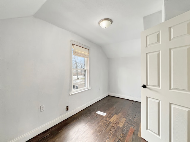 bonus room featuring lofted ceiling and dark hardwood / wood-style flooring