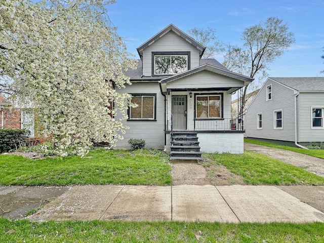 bungalow-style house featuring a porch and a front lawn