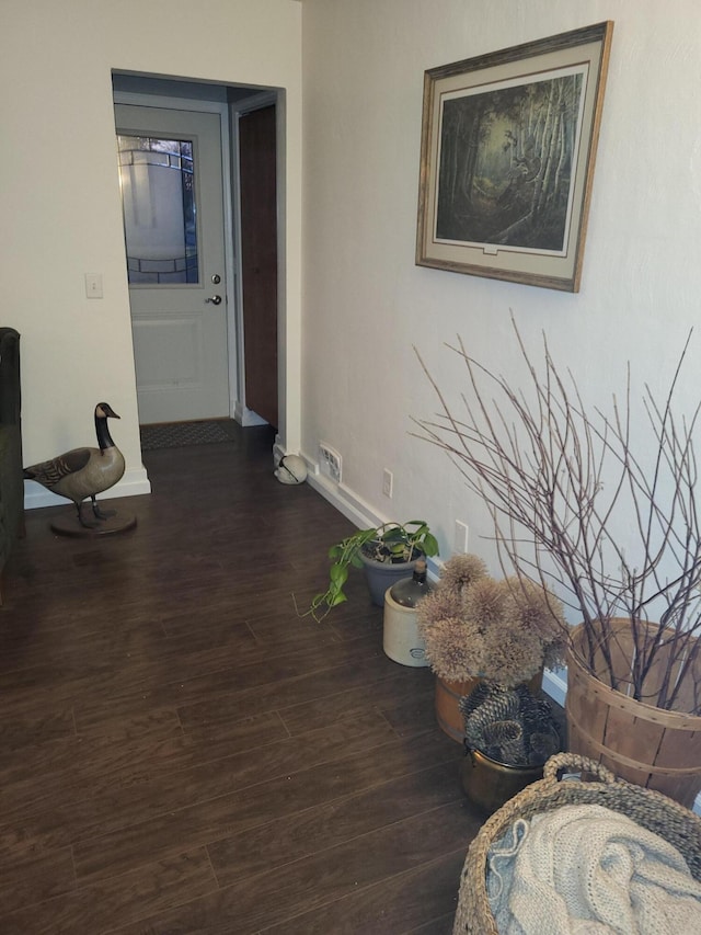 corridor with dark hardwood / wood-style flooring