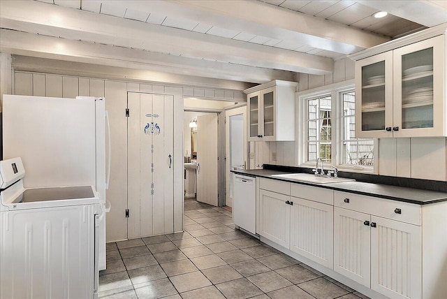 kitchen featuring sink, dishwasher, white cabinetry, beam ceiling, and washer / clothes dryer