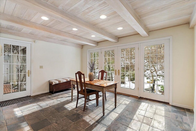 dining space featuring french doors, wood ceiling, and beam ceiling