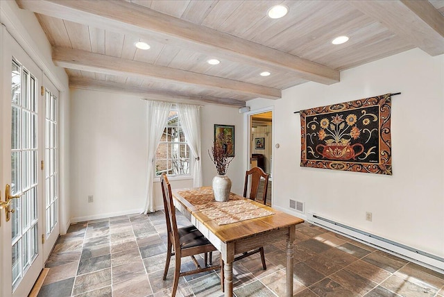 dining room with a baseboard heating unit, wooden ceiling, and beamed ceiling