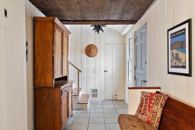 interior space featuring light tile patterned flooring, vaulted ceiling, and wooden ceiling