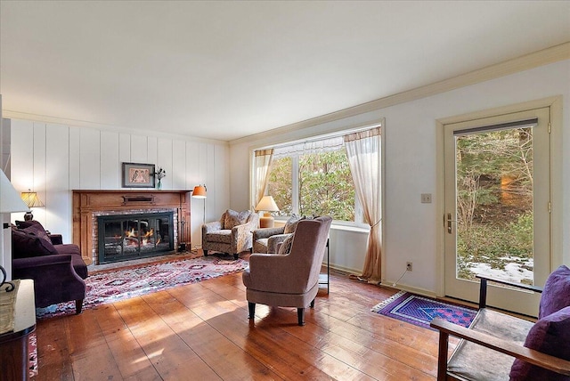 living room with wood-type flooring and ornamental molding