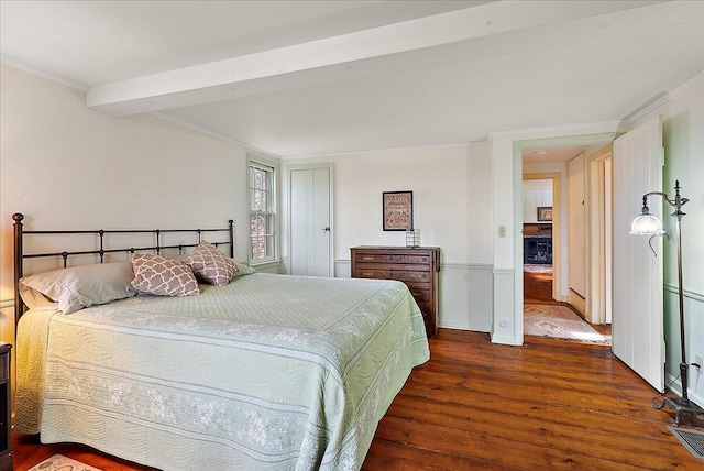 bedroom with ornamental molding and dark hardwood / wood-style flooring