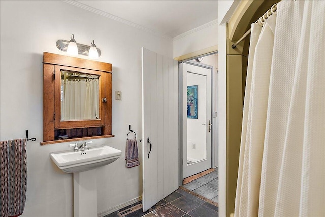 bathroom featuring crown molding and walk in shower