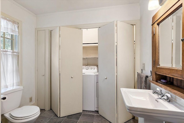 bathroom with washer / clothes dryer, ornamental molding, sink, and toilet