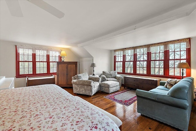 bedroom with beamed ceiling and dark hardwood / wood-style flooring