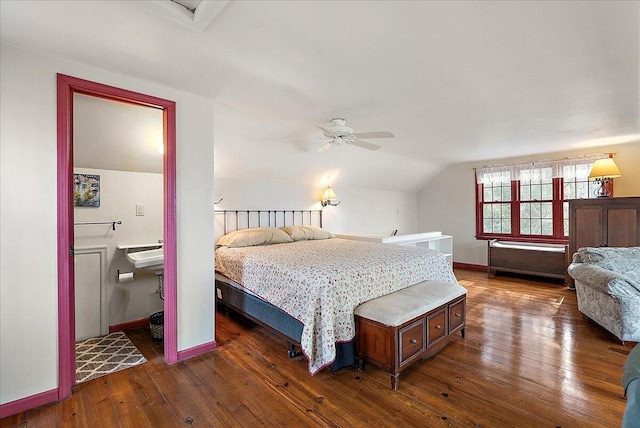 bedroom with dark wood-type flooring and lofted ceiling