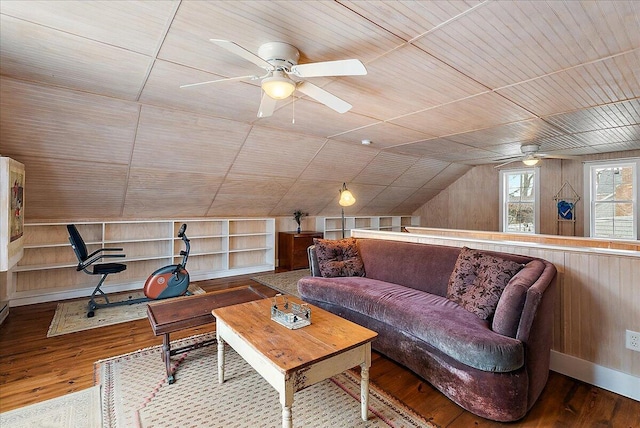 living room with lofted ceiling, wood-type flooring, wooden walls, and wooden ceiling