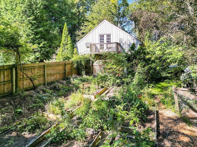 rear view of house featuring a wooden deck