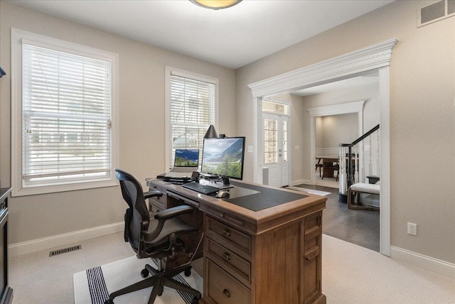 office area featuring a wealth of natural light and light colored carpet