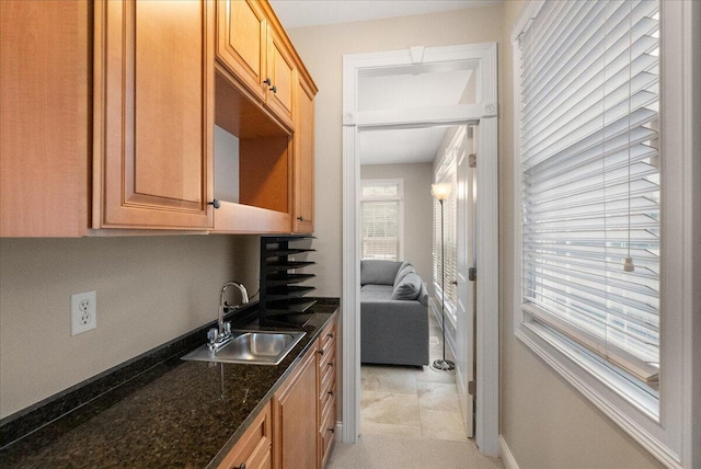 kitchen with sink and dark stone counters