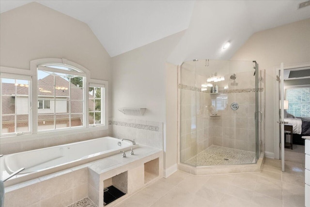 bathroom featuring tile patterned flooring, shower with separate bathtub, and lofted ceiling