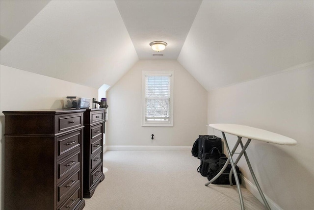 office area featuring light carpet and lofted ceiling