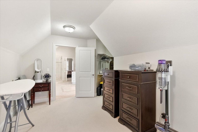 carpeted office space featuring vaulted ceiling