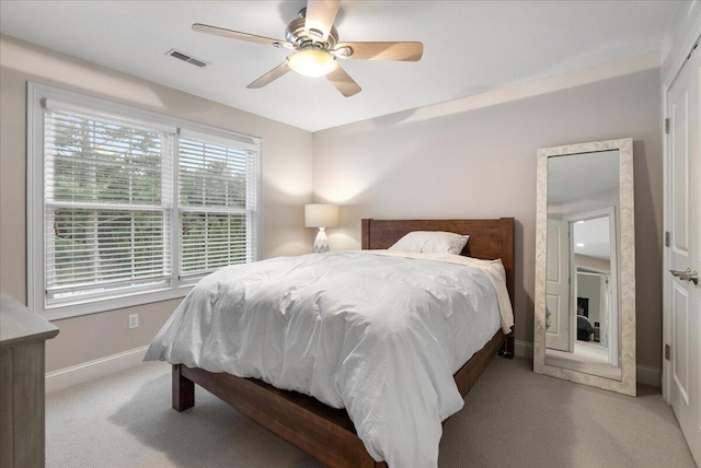 bedroom featuring light carpet and ceiling fan