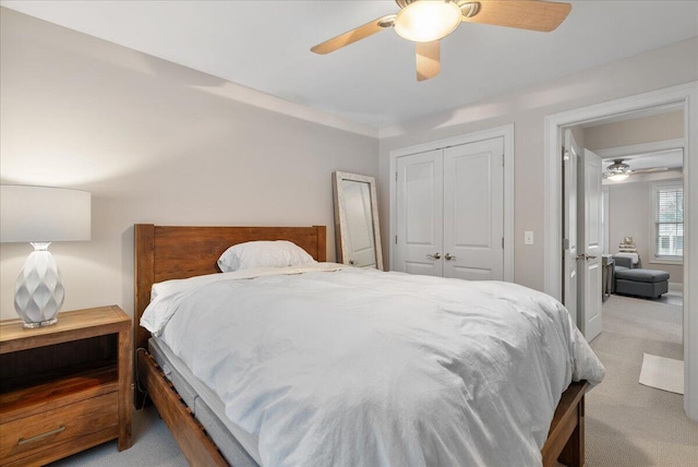 carpeted bedroom featuring ceiling fan and a closet