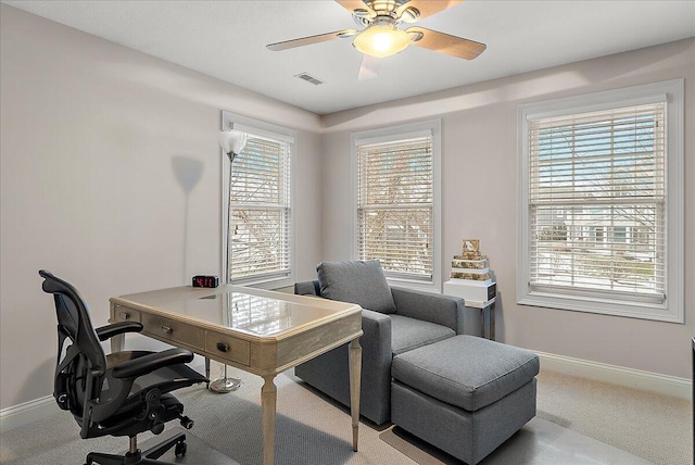 home office featuring light colored carpet and ceiling fan