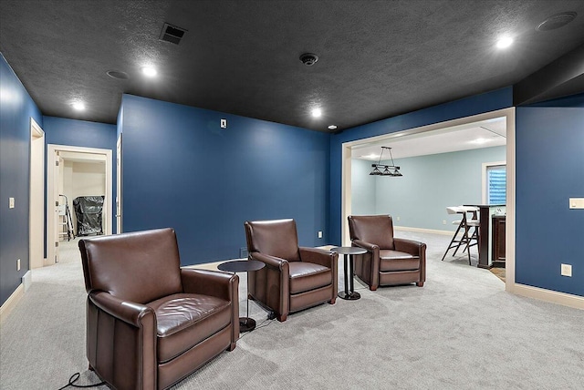 carpeted home theater room with a textured ceiling