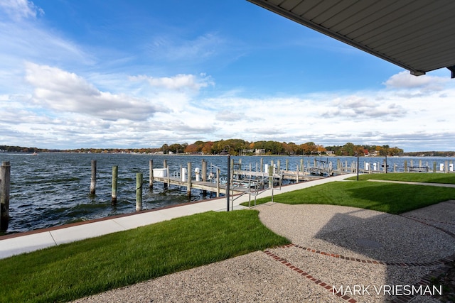 view of dock featuring a water view and a lawn