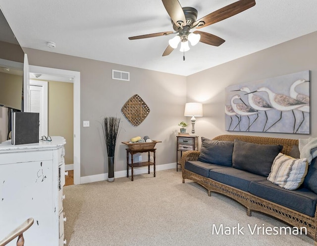 living room featuring ceiling fan and light colored carpet