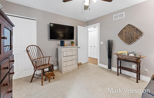 living area featuring ceiling fan