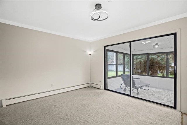 carpeted empty room featuring crown molding and a baseboard heating unit