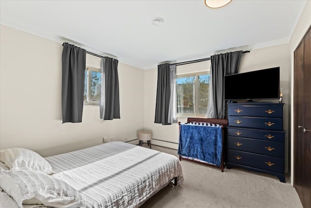 bedroom featuring light carpet and baseboard heating