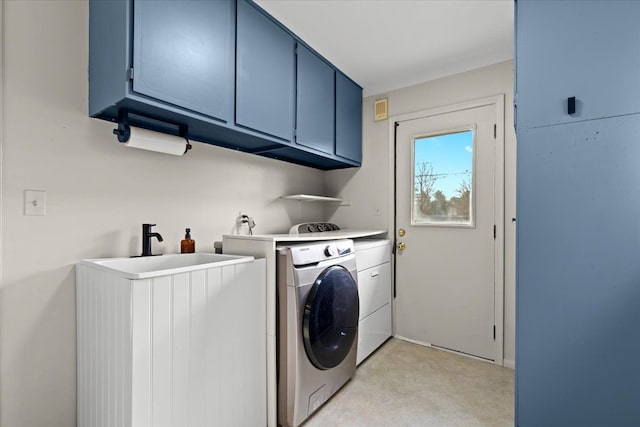 washroom featuring washing machine and dryer and cabinets