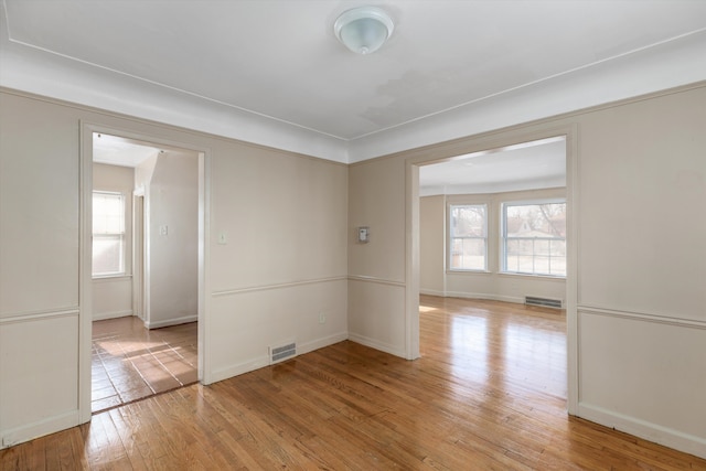 spare room featuring light hardwood / wood-style flooring