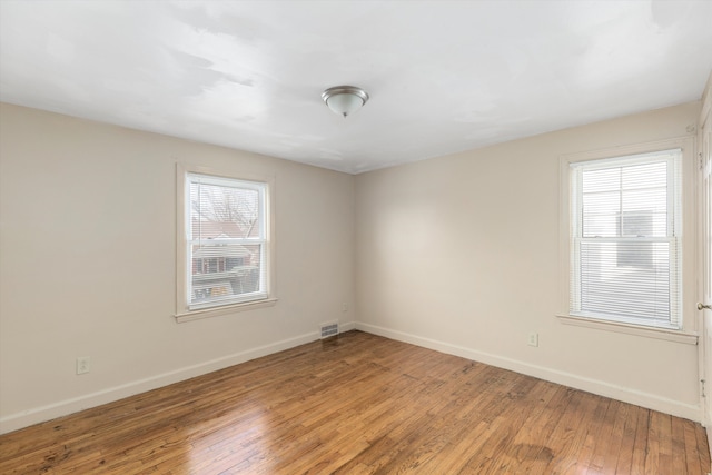 spare room with wood-type flooring