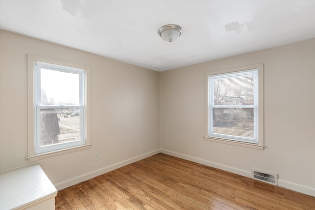 unfurnished room with a healthy amount of sunlight and light wood-type flooring