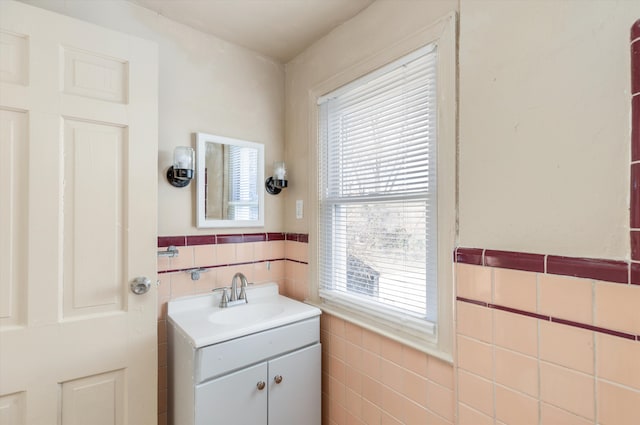 bathroom featuring tile walls and vanity