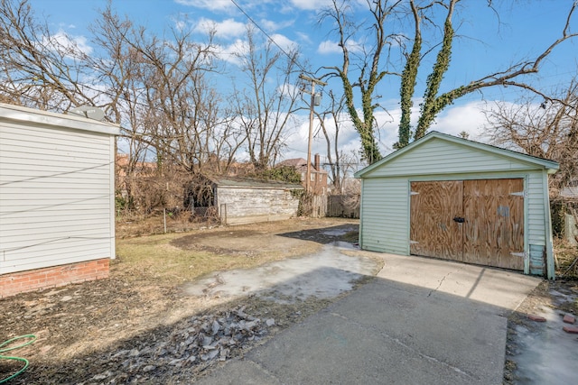 exterior space with a garage and an outdoor structure