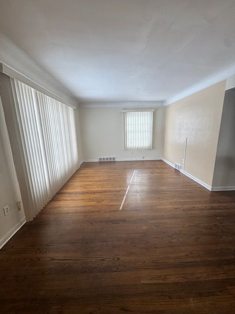 empty room with dark wood-type flooring