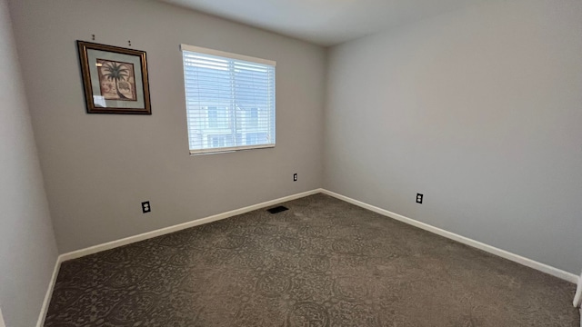 empty room with dark carpet