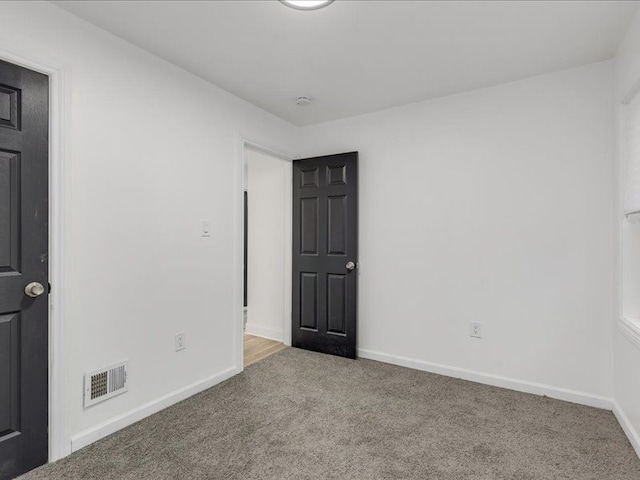 spare room with light colored carpet