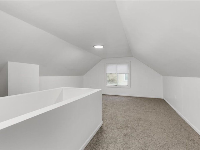 bonus room with lofted ceiling and carpet floors