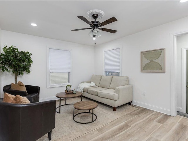 living room featuring ceiling fan and light wood-type flooring