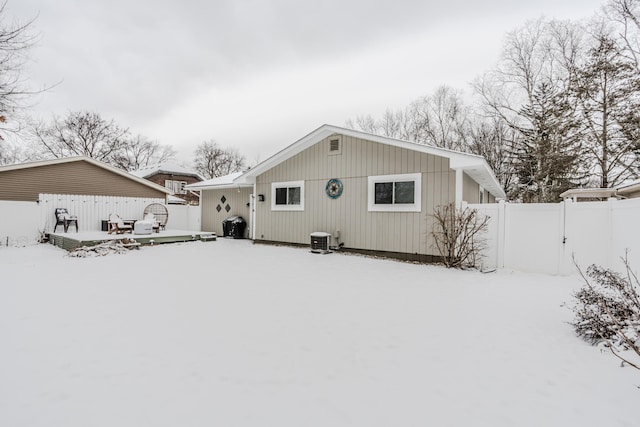 snow covered property featuring a deck and central air condition unit