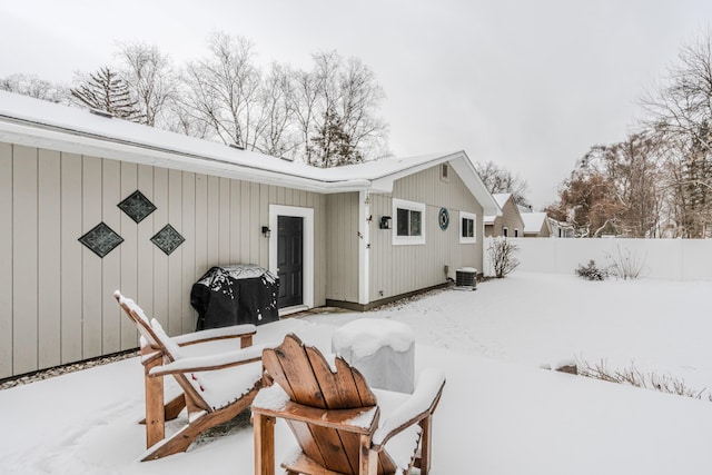 snow covered property featuring cooling unit