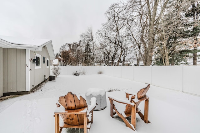 yard covered in snow with central AC