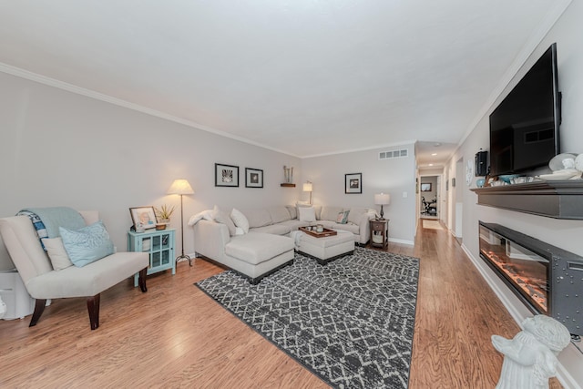 living room featuring ornamental molding and hardwood / wood-style floors